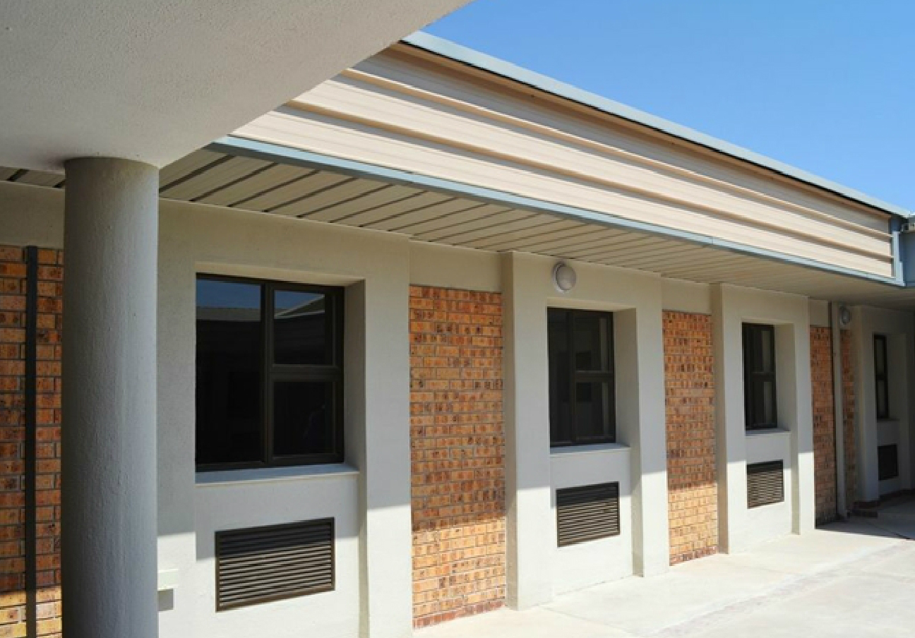 Aluminium-framed windows installed along a brick building facade