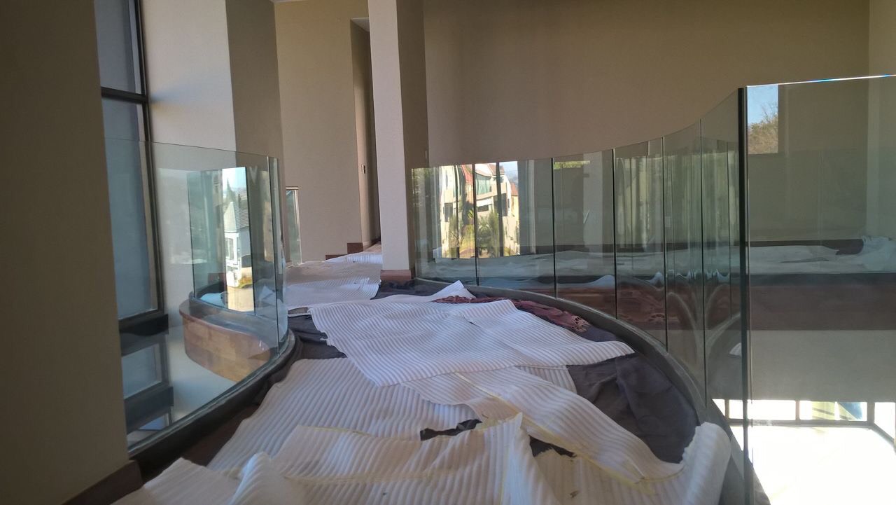 Folding-stacking aluminium doors installed and opened onto an outdoor terrace